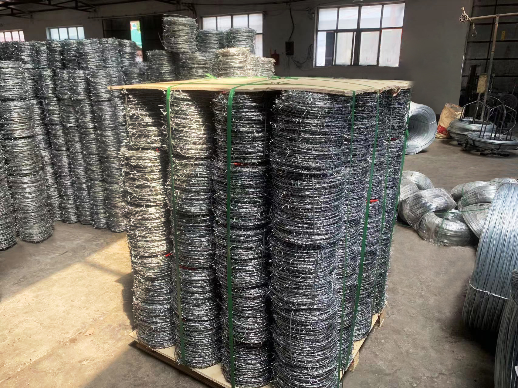 Barbed wire is a type of fencing material consisting of wire strands with sharp barbs or spikes twisted along its length. It is designed to deter or prevent entry by humans and animals by causing discomfort or injury upon contact.